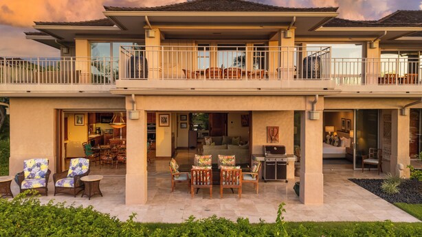 A two-story house with a balcony, outdoor seating area, and a patio. - Elevated 2BR Hillside Villa 4102 at Hualalai – Ocean Views & Island Lifestyle (Kailua Kona)