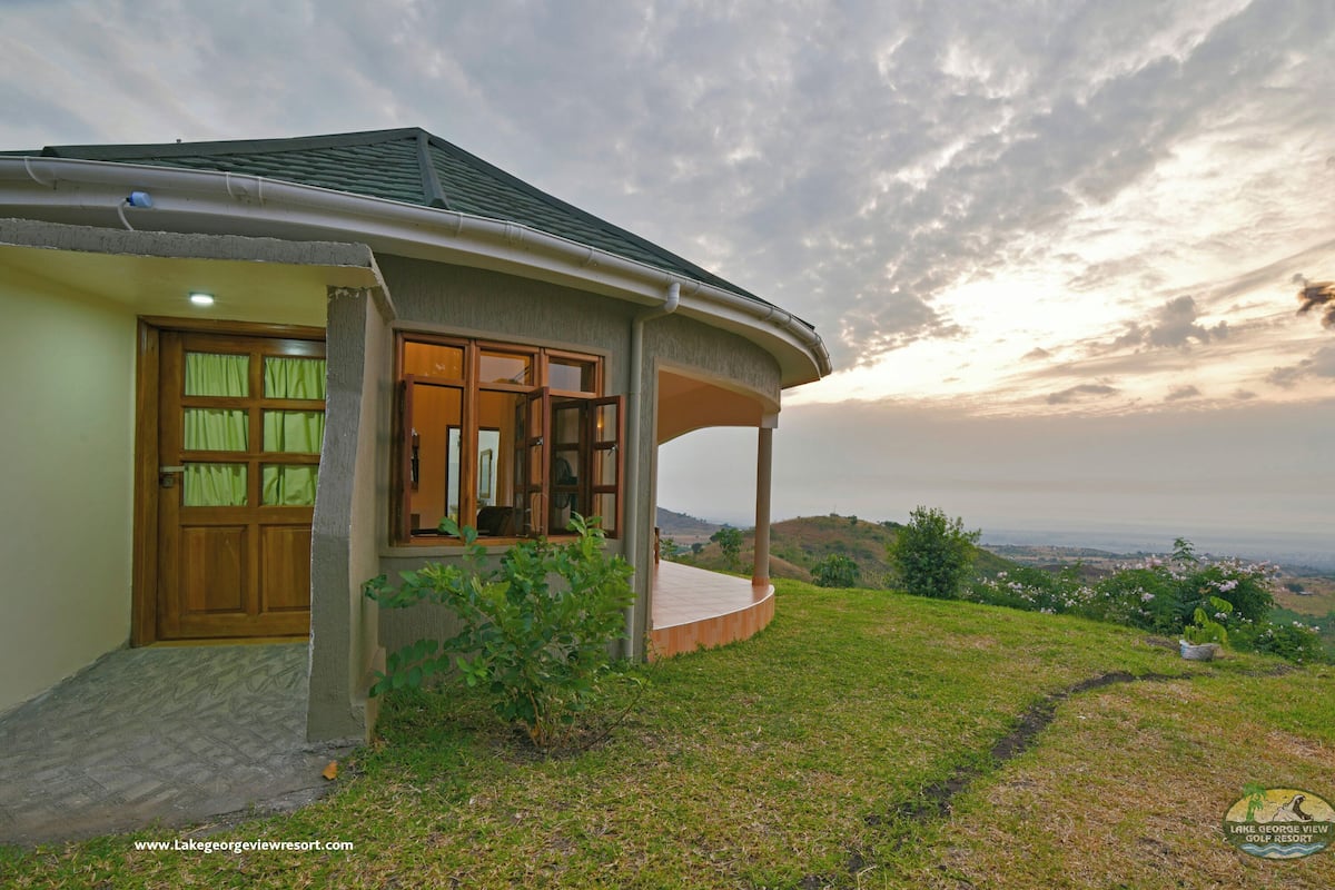 A house with a curved roof and a view of a landscape.