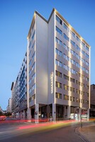 A multi-story hotel with a modern facade, large windows, and a prominent entrance.