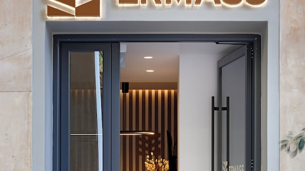 A hotel entrance with a modern design, featuring a glass door and a sign that reads "ERMASS". - ERMASS Athens (Athens)