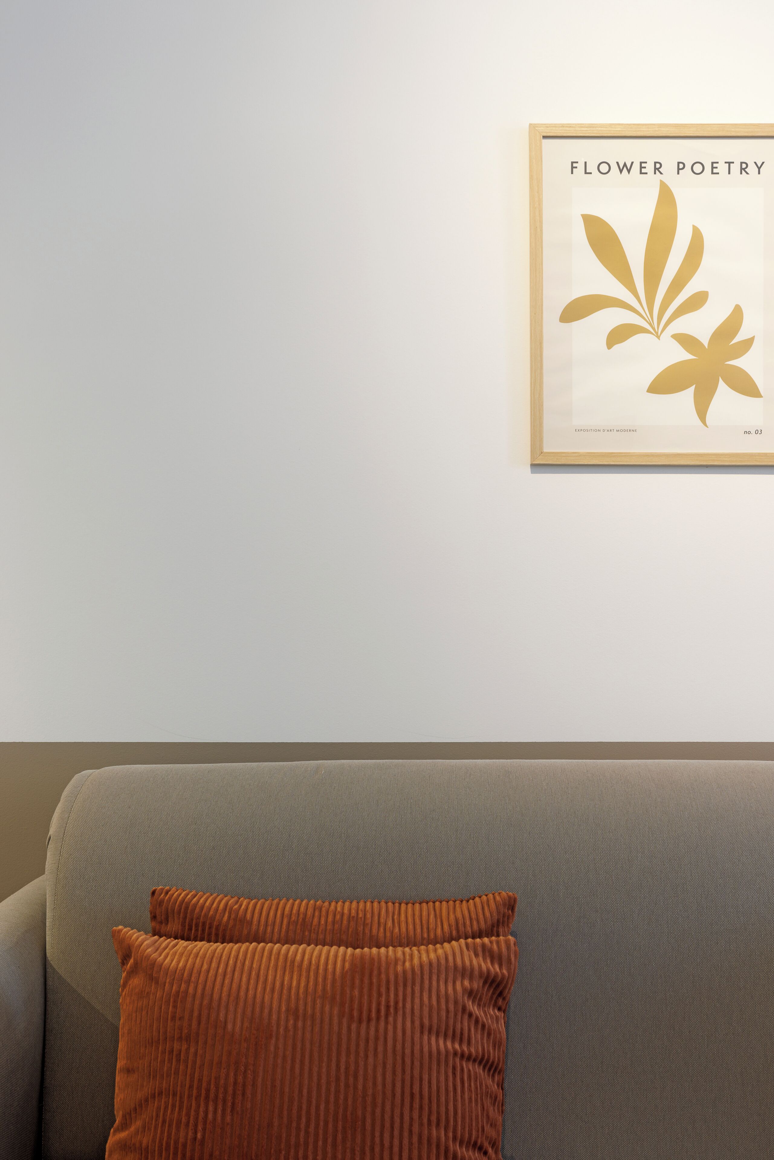 A framed artwork titled "Flower Poetry" on a wall.