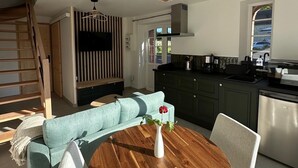 A modern kitchen with dark cabinets, a stainless steel dishwasher, and a built-in oven. - 2-person cocoon gîte in the heart of nature, very bright, 15 minutes from UTAH BEACH (Picauville)