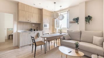 Family Apartment, 1 Bedroom | Living area | 50-inch Smart TV with cable channels