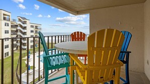 A balcony with a view of a building and a pool. - Summer Winds 436B- 2BR Condo w/ Ocean Views & Pools! (Indian Beach)