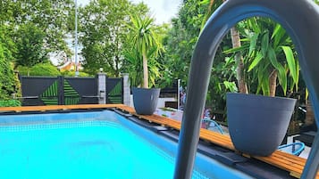 Seasonal outdoor pool, open 8:00 AM to 10:00 PM, pool umbrellas