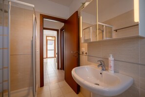 Appartement, terras, uitzicht op tuin | Badkamer | Een douche, gratis toiletartikelen, een haardroger, handdoeken