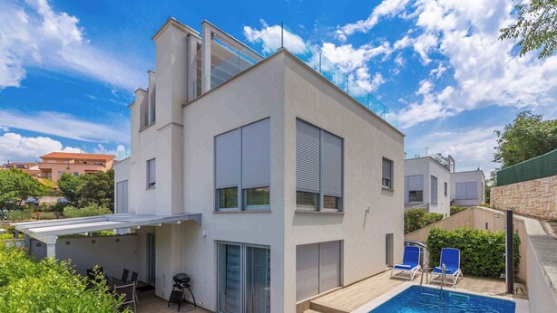 A modern two-story house with a swimming pool, outdoor seating, and a covered patio. - Holiday home with pool for 8 people (Malinska)