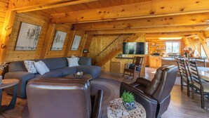 A cozy log cabin interior with a living room, dining area, and kitchen. - Enjoy a cozy cabin near the lake! Sleeps 8,  4 Beds. (Panguitch Lake)