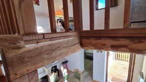 A wooden-framed room with a dining area, a small table, and chairs. - Chambre d'hôte Opale - Refinement, serenity and well-being guaranteed (Puy-l'Évêque)