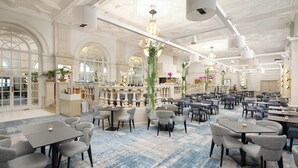 A spacious hotel lobby with multiple seating areas, a reception desk, and a bar. - Doubletree By Hilton Brighton Metropole (Brighton)