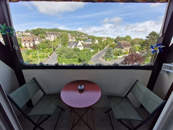 Enjoy a quiet conversation or meal on the balcony with a serene view of the surrounding neighborhood.