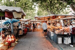Shop for unique goods under a shaded canopy.
