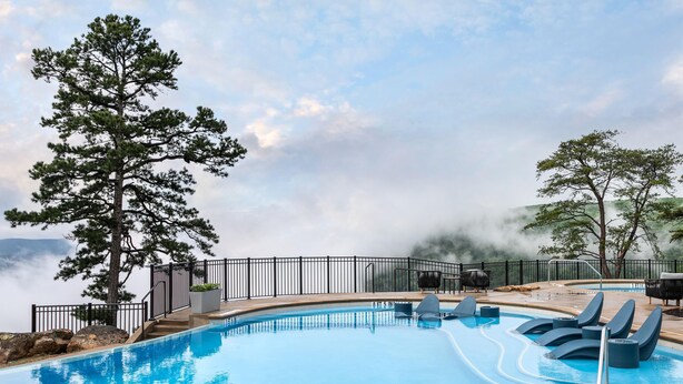 A pool with a view of mountains, a large tree, and a barbecue area. - Cloudland Mclemore Resort Lookout Mountain Curio (Rising Fawn)