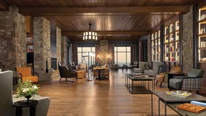 A spacious lobby with wooden flooring, modern furniture, and large windows offering views. - Cloudland Mclemore Resort Lookout Mountain Curio (Rising Fawn)