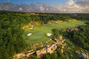 A golf course with multiple holes, surrounded by dense forest and rocky terrain. - Cloudland Mclemore Resort Lookout Mountain Curio (Rising Fawn)