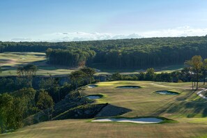 A golf course with multiple bunkers and a forested background. - Cloudland Mclemore Resort Lookout Mountain Curio (Rising Fawn)