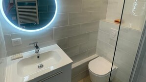 A modern bathroom with a white sink, a toilet, and a glass shower enclosure. - T2 sea view, very quiet. (Saint-Cyr-sur-Mer)