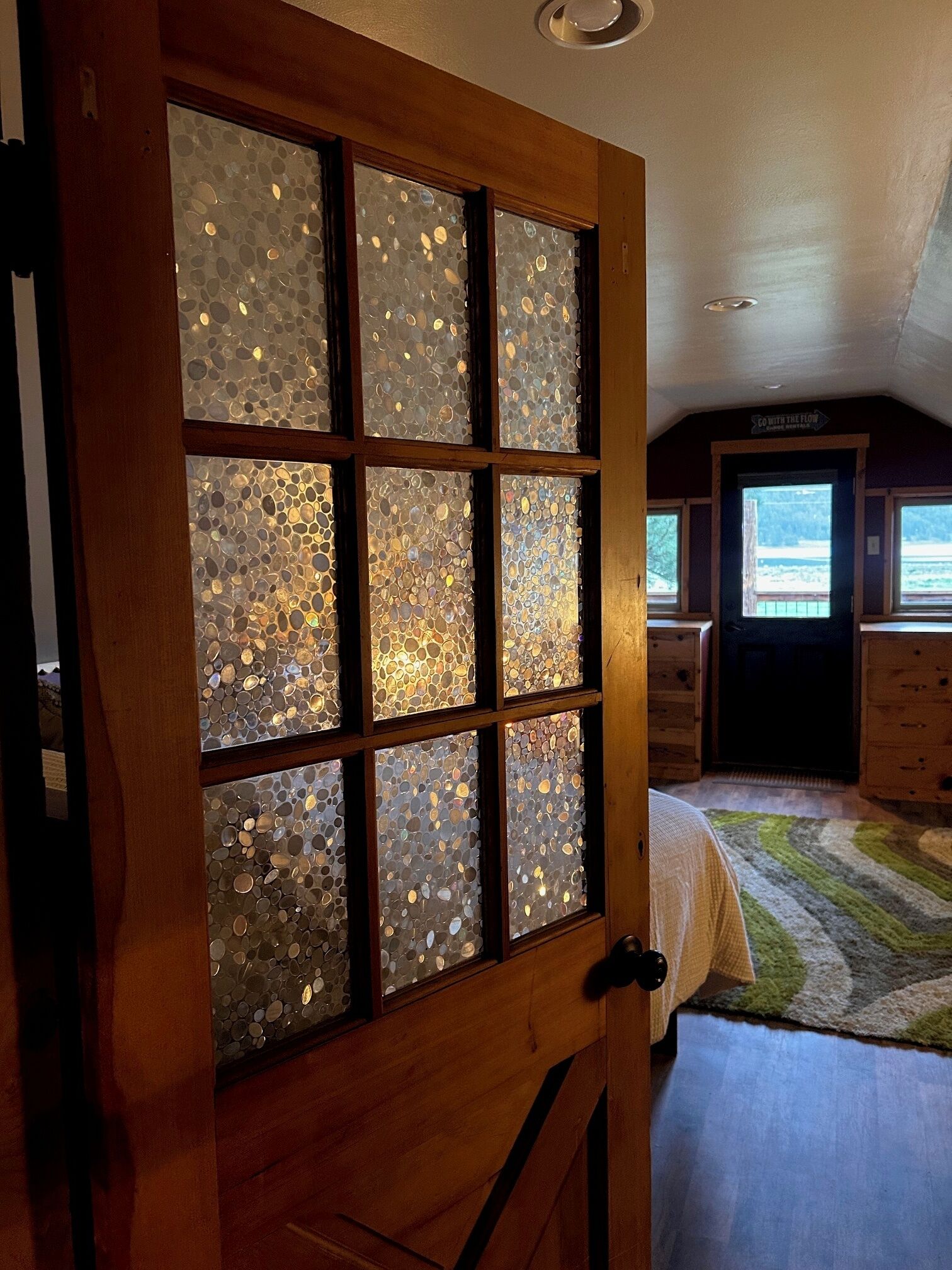 A room with a wooden door featuring frosted glass panels.
