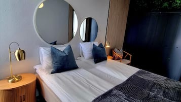 Apartment, Sea View | Down comforters, individually furnished, desk, laptop workspace