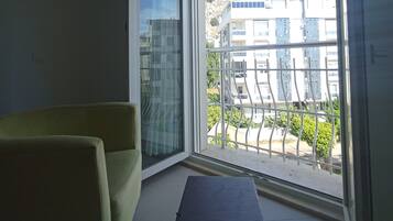 Family Apartment, 1 Bedroom, Balcony, Pool View | Living area | 37-inch Smart TV with satellite channels, MP3 dock