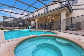 Swim and relax in a pool area surrounded by a deck and lounge chairs.