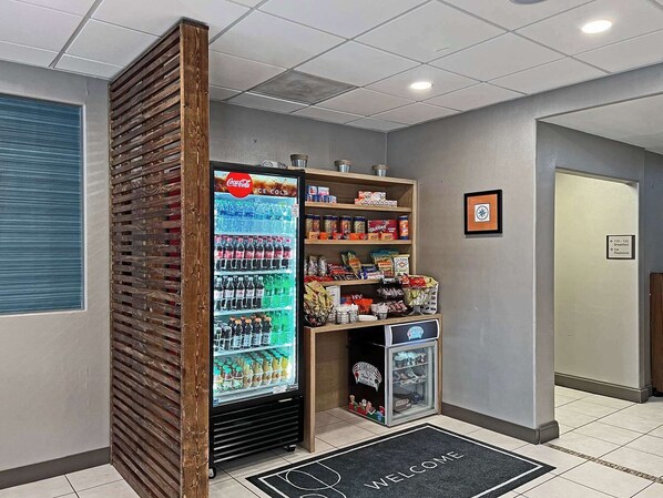 A vending machine with a Coca-Cola refrigerator, snacks, and a small freezer. - Country Inn & Suites by Radisson, Rehoboth Beach - Dewey (Rehoboth Beach)
