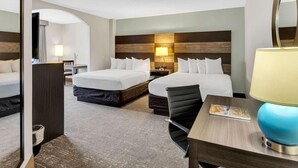 A hotel room with two beds, a desk, a chair, a lamp, and a mirror. - Country Inn & Suites by Radisson, Rehoboth Beach - Dewey (Rehoboth Beach)