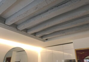 Exposed concrete beams and minimalist design define this stylish hotel room.