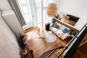 Una sala de estar moderna con un sofá, una mesa de centro y una lámpara colgante.