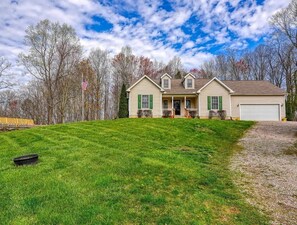 A single-story house with a front porch, a garage, and a well-maintained lawn.