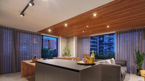 A modern living room with a wooden ceiling, a central island, and a view of a cityscape through large windows.