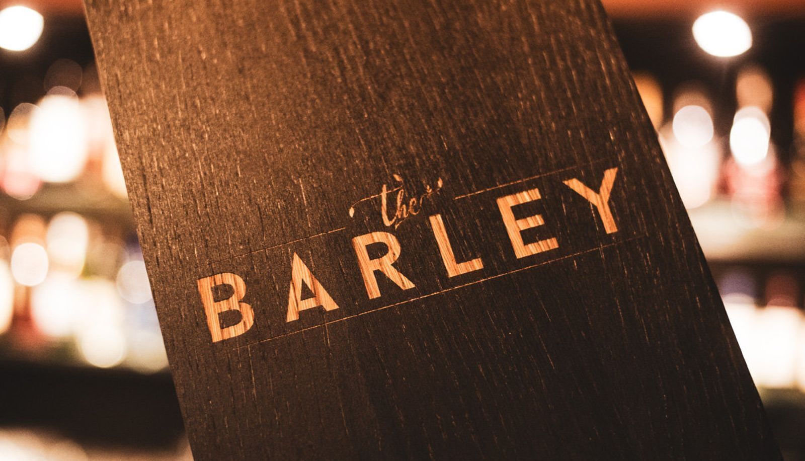 A wooden post with the name "The BARLEY" carved into it.