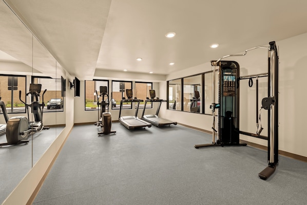 A modern gym with treadmills, elliptical machines, and weightlifting equipment. - LivAway Suites Nashville- Smyrna (Smyrna)