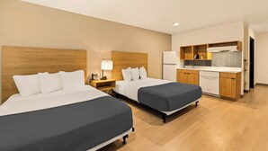 A hotel room with two beds, a kitchenette, and a bathroom. - LivAway Suites Nashville- Smyrna (Smyrna)