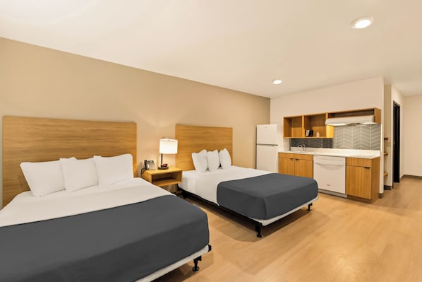 A hotel room with two beds, a kitchenette, and a bathroom. - LivAway Suites Nashville- Smyrna (Smyrna)