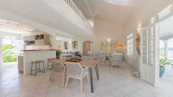 A spacious open-plan living area with a kitchen, dining table, and seating.