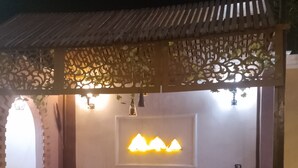 An outdoor seating area with a sofa, a table, and a laptop. - Terrific 4-bedroom hotel in Luxor with AC, WiFi and swimming pool  (Luxor)