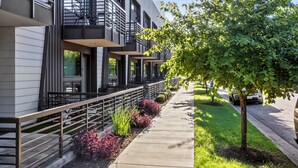 A modern multi-story building with balconies, outdoor seating, and a well-maintained lawn. - Holly House (Austin)