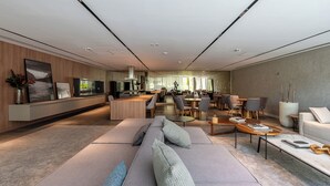 Un intérieur moderne comprenant un espace de vie, un coin repas et une cuisine.