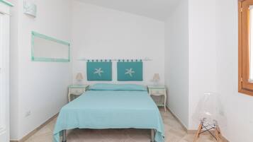 A bedroom with a bed, two nightstands, a chair, a mirror, and star decorations on the wall.