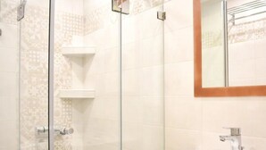 A bathroom with a glass shower enclosure, a white sink, and a mirror with a wooden frame. - Apartment 'Manolika Studio 5' with Sea View, Wi-Fi and Air Conditioning (Kythnos)