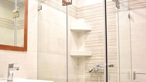 A bathroom with a sink, mirror, and glass-enclosed shower area. - Apartment 'Manolika Studio 4' with Sea View, Wi-Fi and Air Conditioning (Kythnos)