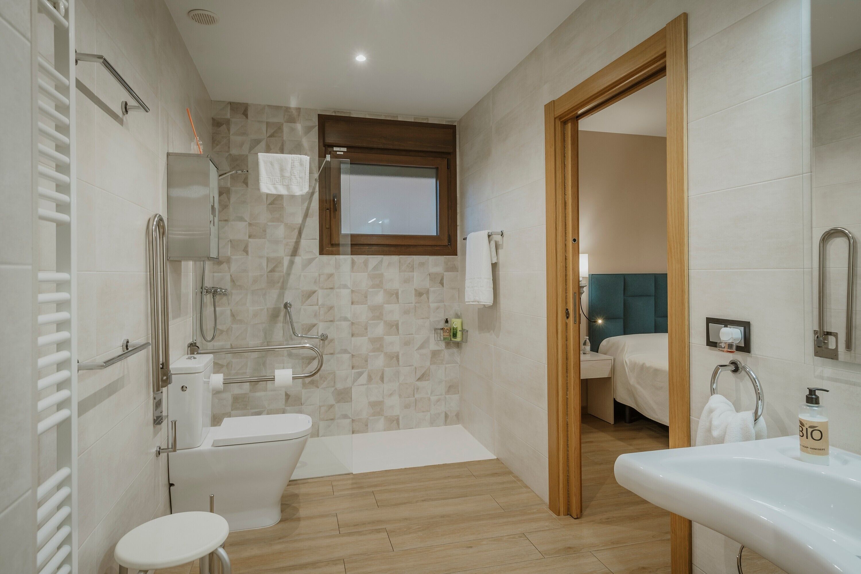 A modern bathroom with a toilet, bidet, and sink.