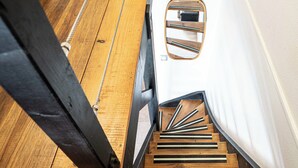 A wooden staircase with a handrail and a mirror on the wall. - Honoré apartment with views of the marina and golf course 2mn from beaches (Saint-François)