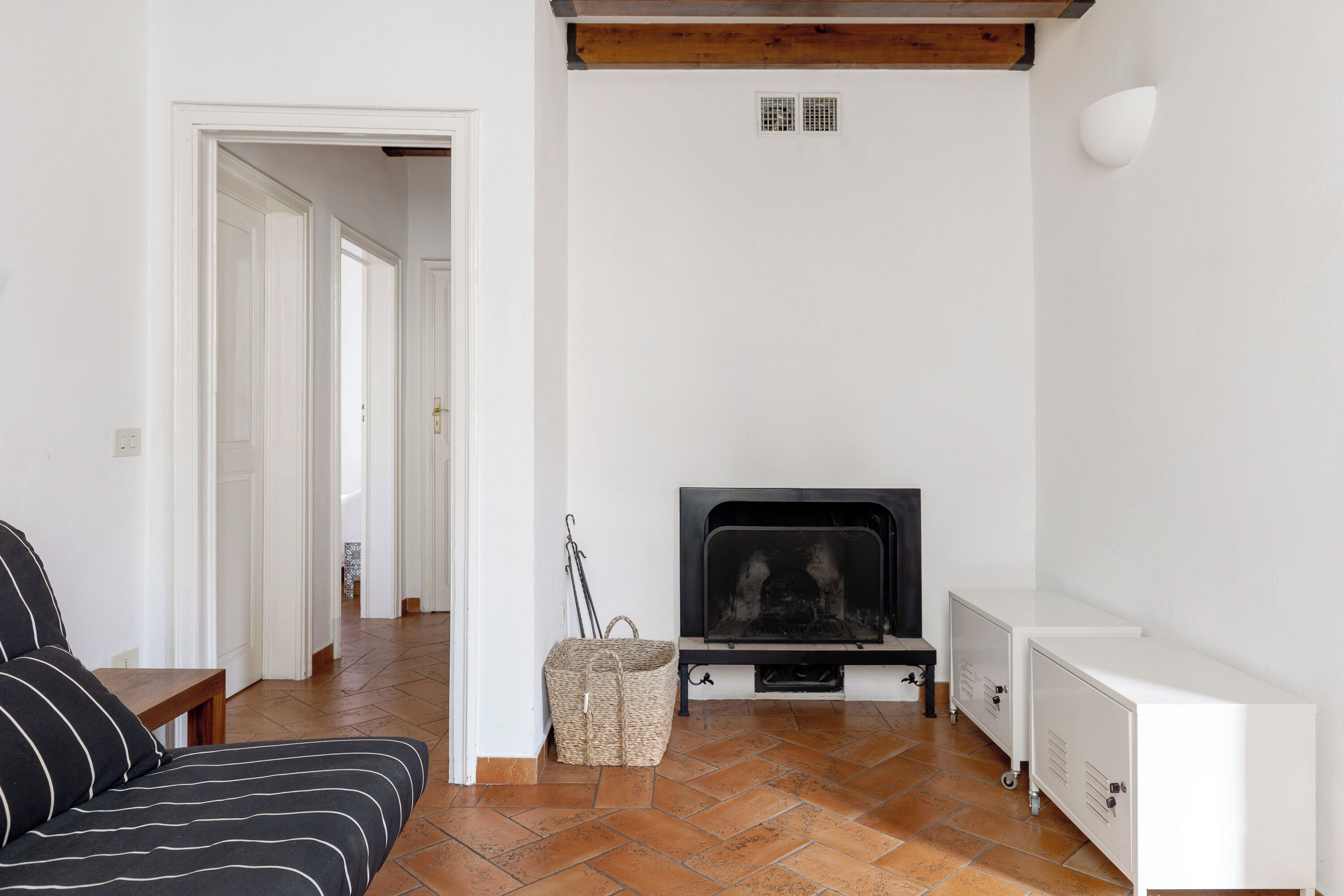 Een woonkamer met een open haard, een bank en een zitbank.
