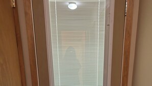 A door with a frosted glass window and a metal handle.