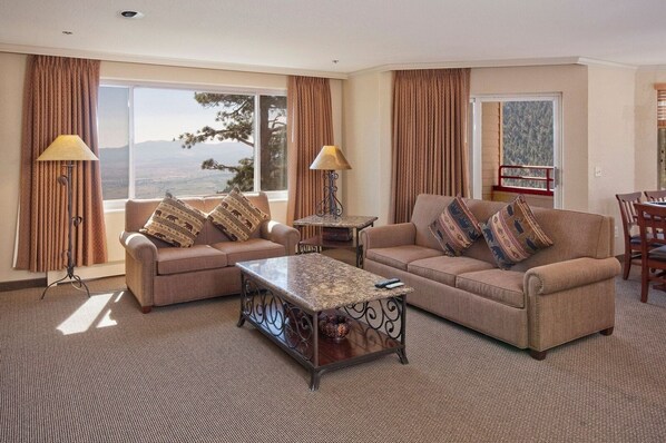 A hotel room with two sofas, a coffee table, and a dining table with chairs. - Luxe Heavenly Villa | Pools, Fitness Centre (Stateline)