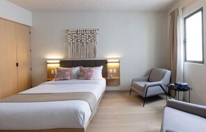 Relax in comfort with a large bed, bedside tables, and a cozy reading nook.