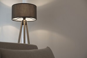A floor lamp with a cylindrical shade and a tripod base. - Studio Stratos With 1 Bathrooms (Athens)