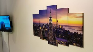A wall-mounted artwork of a cityscape at sunset. - Studio Stratos With 1 Bathrooms (Athens)